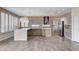 Large, light-filled kitchen featuring marble countertops, stainless appliances, and a large island at 8113 Gothic Ave, Las Vegas, NV 89117