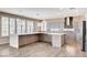 Beautiful kitchen features an island with modern pendants and stainless steel appliances at 8113 Gothic Ave, Las Vegas, NV 89117