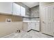 Functional laundry room with ample cabinet space, countertop, and tiled backsplash at 8113 Gothic Ave, Las Vegas, NV 89117