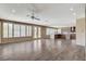 Open-concept living space with wood-look floors and an abundance of natural light at 8113 Gothic Ave, Las Vegas, NV 89117