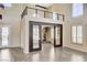 Expansive living area featuring a spiral staircase, wood flooring, and abundant natural light at 8113 Gothic Ave, Las Vegas, NV 89117