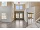 Spacious living room with hardwood floors, plantation shutters, a stone accent wall, and a grand staircase at 8113 Gothic Ave, Las Vegas, NV 89117
