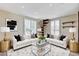Cozy living room with a spiral staircase, modern decor, and ample natural light at 8113 Gothic Ave, Las Vegas, NV 89117