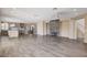 Spacious living area with fireplace open to the kitchen, features wood-look flooring at 8113 Gothic Ave, Las Vegas, NV 89117