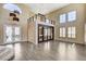 Open-concept living area boasts soaring ceilings, wood floors, and a cozy spiral staircase at 8113 Gothic Ave, Las Vegas, NV 89117