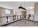 Second-story loft area with dark wood railing, modern light fixtures, and scenic views at 8113 Gothic Ave, Las Vegas, NV 89117