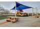 Community playground featuring colorful play structures, a picnic table, and benches for relaxation at 8113 Gothic Ave, Las Vegas, NV 89117