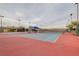 Community tennis courts with blue and red playing surfaces, lighting for nighttime play, and shade canopies at 8113 Gothic Ave, Las Vegas, NV 89117