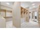 Spacious walk-in closet with custom shelving units and carpeted floors at 8113 Gothic Ave, Las Vegas, NV 89117