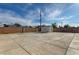 Spacious backyard featuring a detached shed, concrete patio, and block fencing at 813 E Bartlett Ave, North Las Vegas, NV 89030