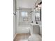 Chic bathroom featuring white marble tile in the tub/shower, black accents, and gray vanity at 813 E Bartlett Ave, North Las Vegas, NV 89030