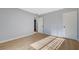 This bedroom has wood-look flooring, light blue walls, and two white doors at 813 E Bartlett Ave, North Las Vegas, NV 89030