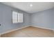 Bedroom featuring wood-look flooring, light blue walls, and a window at 813 E Bartlett Ave, North Las Vegas, NV 89030
