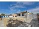 A large driveway offers ample parking space, complemented by a secure gate and partial privacy fence at 813 E Bartlett Ave, North Las Vegas, NV 89030