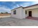 Home's front exterior with gated driveway, showcasing the entrance and low maintenance landscaping at 813 E Bartlett Ave, North Las Vegas, NV 89030