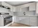 Updated kitchen with white cabinets, modern appliances, and a stainless steel sink at 813 E Bartlett Ave, North Las Vegas, NV 89030