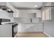 Kitchen featuring sleek white cabinets, modern fixtures, and ample counter space for food preparation at 813 E Bartlett Ave, North Las Vegas, NV 89030