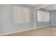 Corner of a living room with new vinyl floors, modern baseboards and large windows at 813 E Bartlett Ave, North Las Vegas, NV 89030