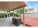 Backyard with a covered patio area, a wooden deck and privacy fencing at 8221 Stoneheather Ct, Las Vegas, NV 89117
