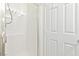 All-white shower features tiled walls and glass door at 8221 Stoneheather Ct, Las Vegas, NV 89117