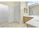 Bright bathroom with a double sink vanity, tile flooring, and a large walk-in closet at 8221 Stoneheather Ct, Las Vegas, NV 89117