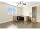 The room features a neutral wall color, hardwood flooring, a fan/light fixture, a window, and a wood desk at 8221 Stoneheather Ct, Las Vegas, NV 89117