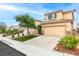 Lovely two-story home features desert landscaping, a two-car garage, and a private driveway at 8221 Stoneheather Ct, Las Vegas, NV 89117