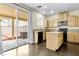 Bright kitchen features an island, modern appliances, and a sliding door to the backyard at 8221 Stoneheather Ct, Las Vegas, NV 89117