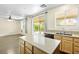 Bright kitchen boasts a center island, laminate countertops, and sliding glass doors to backyard at 8221 Stoneheather Ct, Las Vegas, NV 89117