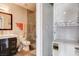 Modern bathroom featuring a sleek vanity, toilet, glass enclosed shower, and washer/dryer combo at 83 E Agate Ave # 207, Las Vegas, NV 89123