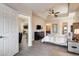 Comfortable bedroom with ensuite, ceiling fan, and a view to the kitchen area at 83 E Agate Ave # 207, Las Vegas, NV 89123