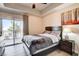 Bedroom features a bed, dresser, and sliding glass doors leading to a balcony at 83 E Agate Ave # 207, Las Vegas, NV 89123