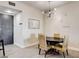 The dining area features woven chairs, modern lighting, and easy access to the home's entryway at 83 E Agate Ave # 207, Las Vegas, NV 89123