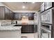 Open-concept kitchen features stainless steel appliances and granite countertops, ready for cooking at 83 E Agate Ave # 207, Las Vegas, NV 89123