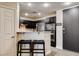 Modern kitchen features stainless steel appliances, granite counters, and dark cabinets at 83 E Agate Ave # 207, Las Vegas, NV 89123
