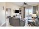 Comfortable living room with cozy sofas, leading to a bright balcony and modern TV setup at 83 E Agate Ave # 207, Las Vegas, NV 89123