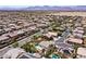 Scenic neighborhood aerial shot shows variety of homes with desert backdrop, some featuring private backyard pools at 9008 Sawhill Pond St, Las Vegas, NV 89131