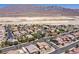 Expansive aerial view of a residential area with mature landscaping against a desert and mountain backdrop at 9008 Sawhill Pond St, Las Vegas, NV 89131