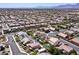 Wide aerial shot showcases a neighborhood with homes that feature backyard pools and solar panels at 9008 Sawhill Pond St, Las Vegas, NV 89131