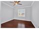 Bright bedroom showcasing hardwood floors, a ceiling fan and shuttered windows at 9008 Sawhill Pond St, Las Vegas, NV 89131