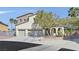 Charming two-story home with a three-car garage and well-maintained front yard landscaping at 9008 Sawhill Pond St, Las Vegas, NV 89131
