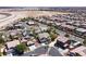 A wide aerial view of a residential community, featuring houses with desert landscaping, and a mountain backdrop at 9008 Sawhill Pond St, Las Vegas, NV 89131