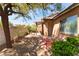Charming backyard with a covered patio, lush landscaping, and brick accents for outdoor enjoyment at 9025 Loggers Mill Ave, Las Vegas, NV 89143