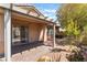 Cozy covered patio with a brick floor, perfect for outdoor dining and relaxation in the landscaped backyard at 9025 Loggers Mill Ave, Las Vegas, NV 89143