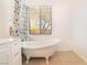 Elegant bathroom featuring a classic clawfoot tub and bright natural light through the window at 9025 Loggers Mill Ave, Las Vegas, NV 89143