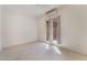 Well-lit bedroom with neutral walls, tile flooring, a mini split system, and access to an outdoor patio at 9025 Loggers Mill Ave, Las Vegas, NV 89143