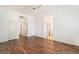 Spacious bedroom with wood-look floors and access to multiple rooms at 9025 Loggers Mill Ave, Las Vegas, NV 89143