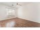 This bedroom is spacious with light-colored wood-look floors and ceiling fan at 9025 Loggers Mill Ave, Las Vegas, NV 89143
