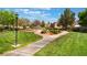 Picturesque community park featuring manicured lawns, mature trees, and a walking path at 9025 Loggers Mill Ave, Las Vegas, NV 89143