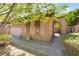 Beautiful exterior of a home with an arched gate leading to a private courtyard and a two-car garage at 9025 Loggers Mill Ave, Las Vegas, NV 89143